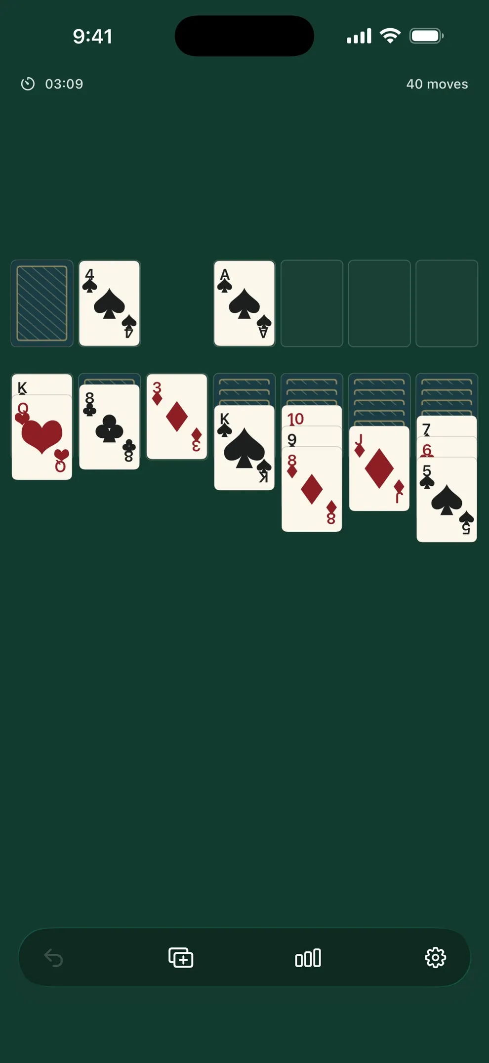 The real Quiet Solitaire game screen, with cream cards arranged on a deep green table